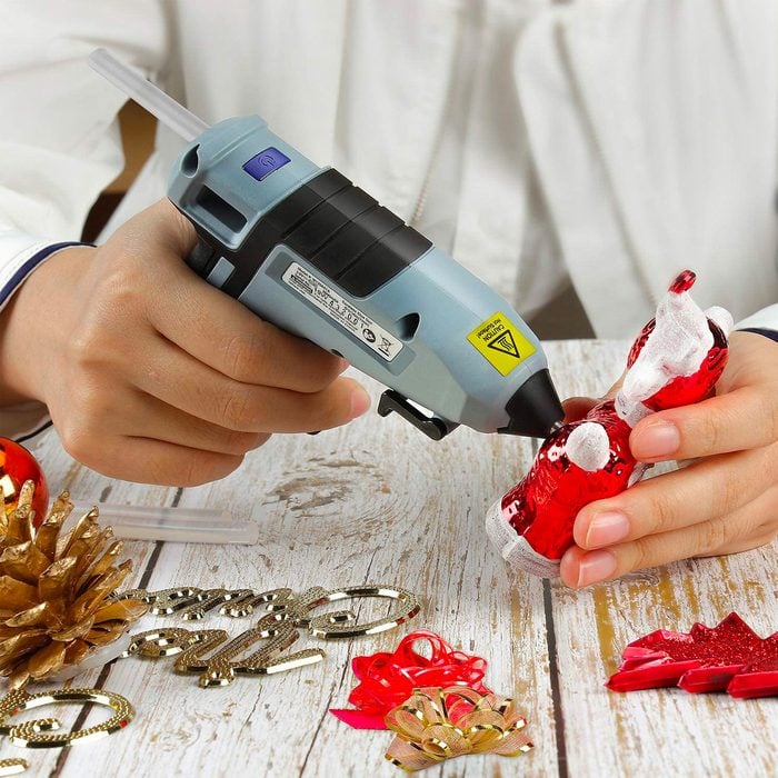 someone using hot glue gun for crafts